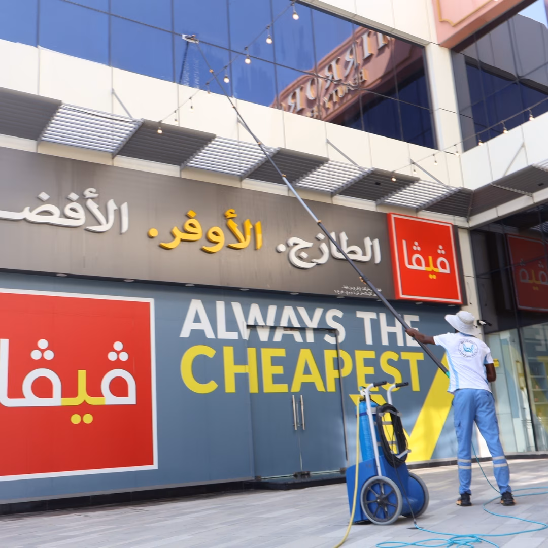 Carbon fiber water-fed pole reaching high windows on a RAK villa for safe, scaffold-free cleaning.